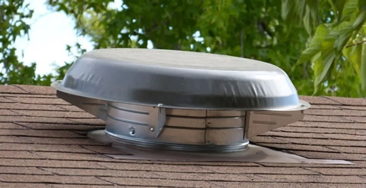 attic fan installation services with low-profile roof ventilation unit in Des Moines, IA