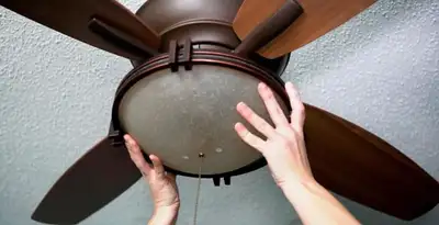 Ceiling fan repair and reinstallation on ceiling mount in Des Moines, IA