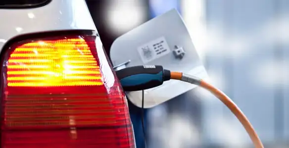 Electric car plugged into EV charger after professional installation in Des Moines, IA