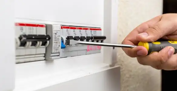 electrical panel upgrade service showing technician adjusting circuit breakers during system upgrade in Des Moines, IA