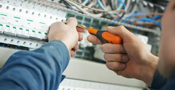 electrical service showing licensed electrician performing electrical panel maintenance and adjustments in Des Moines, IA