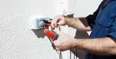 Electrician performing home electrical outlet and wiring inspection in Des Moines, IA