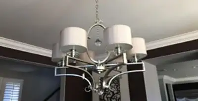 Modern chandelier installation with multiple light fixtures in Des Moines, IA