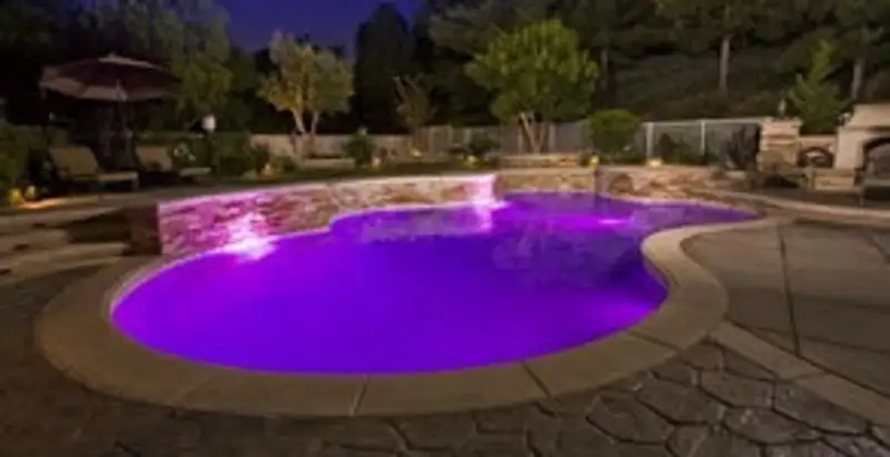 pool light installation and repair services illuminating a residential swimming pool in Des Moines, IA