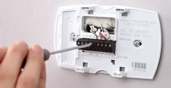 Thermostat installation service with proper wiring and secure wall mounting in Des Moines, IA