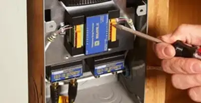 Whole home surge protection device being installed by a licensed electrician to protect electrical systems in Des Moines, IA